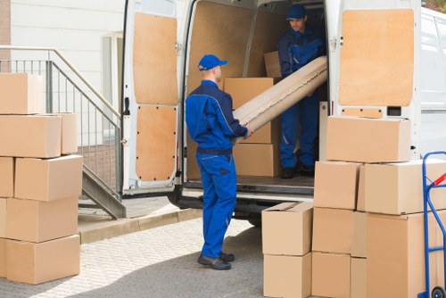 Moving team reviewing safety procedures beside a van