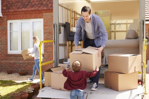 Man with van loading household items for transport