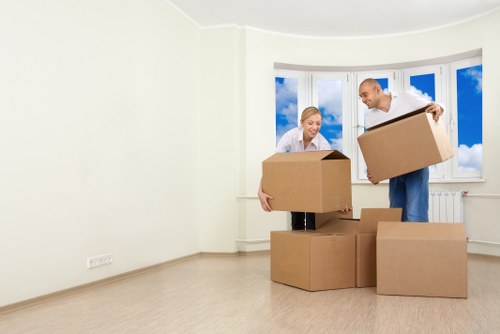 Local moving helper loading boxes near New Eltham homes